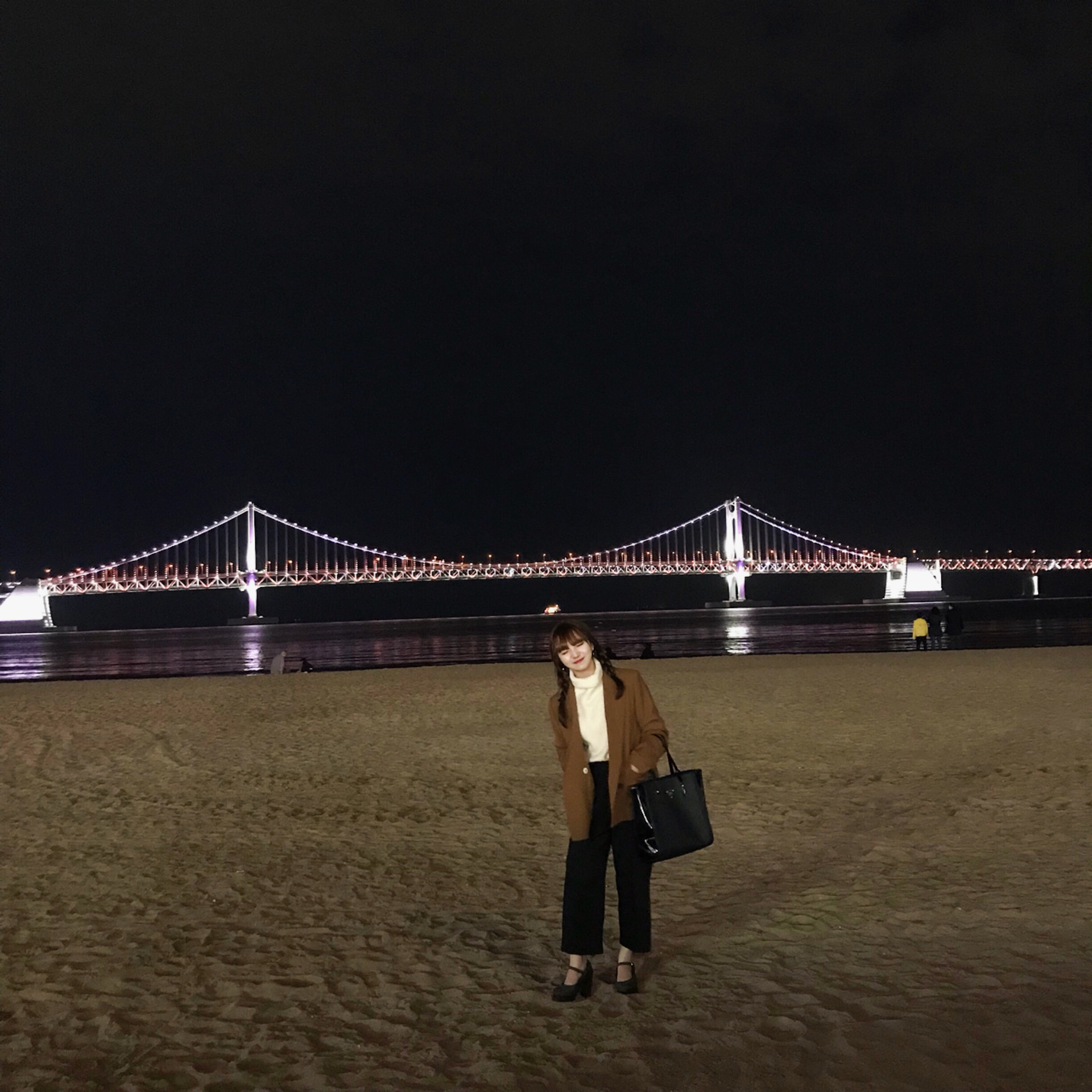 Jinny at Gwangalli Beach with Gwangan Bridge at night in Busan